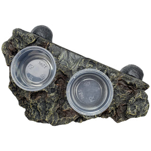 A magnetic feeding ledge with two cups, designed to be attached to terrarium glass, with a realistic rock texture.